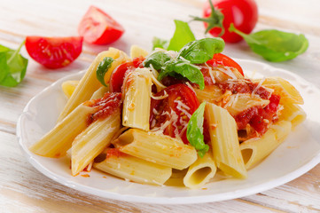 Penne pasta with a  bolognese  sauce on the white wooden  table