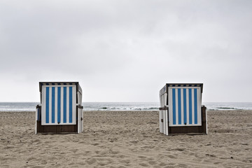 Two beach chairs on a cloudy day