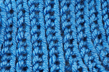 Fototapeta na wymiar Knit woolen blue cloth macro
