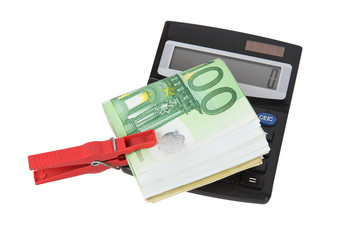 Euro bills held together by a red clothespin with calculator