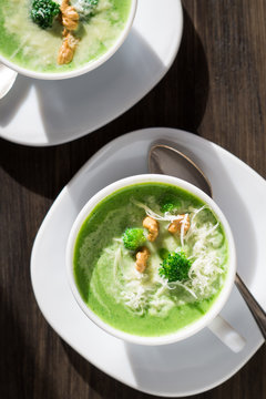 Broccoli cream soup with walnuts and parmesan