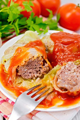 Cabbage stuffed with fork in plate on board