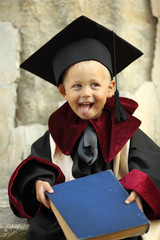 funny little boy graduate of the University