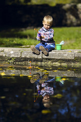 boy fishing in the autumn park