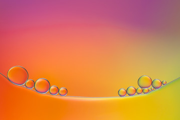 colorful drops of oil and air bubbles on the water