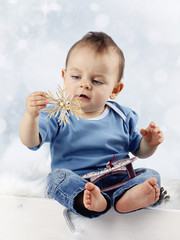 Little child with straw christmas decoration
