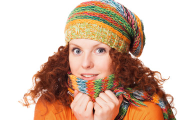 Freezing young woman hiding behind her scarf
