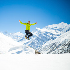 Fototapeta na wymiar Happy man jumping success in mountains