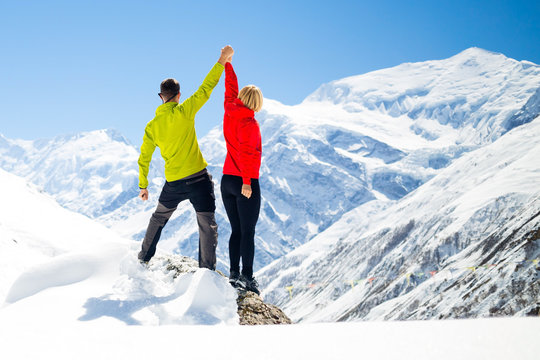 Couple Hiking Man And Woman Success In Winter Mountains