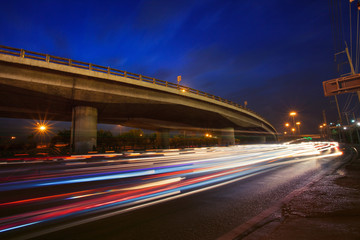 Fototapeta na wymiar traffic lighting on rush hour road and express ways bridge again