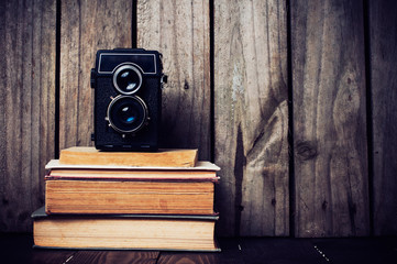 camera and a stack of books