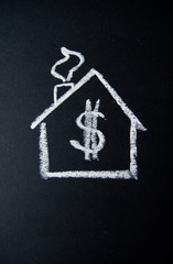 house with dollar sign written with chalk on blackboard, mortgage and finance concept