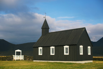 Fototapeta na wymiar Black Wooden church in autumn in Budir, Iceland