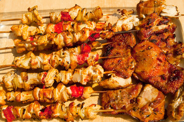 Roast chicken meat sticks on barbecue