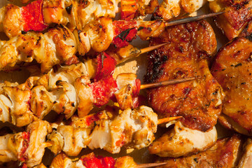 Roast chicken meat sticks on barbecue
