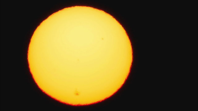Sun with sunspots, telescope view, slow motion