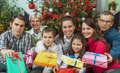 Portrait of happy multigeneration family with Christmas gifts si