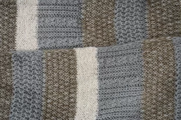 Fotobehang Warme wollen sjaal met verschillende patronen en kleuren © trinetuzun