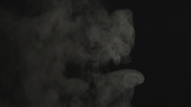 Real white steam isolated on black background with visible