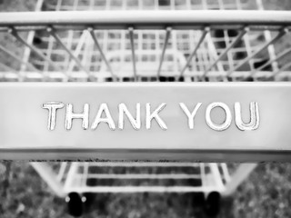 Metal and plastic shopping cart with a thank you note message