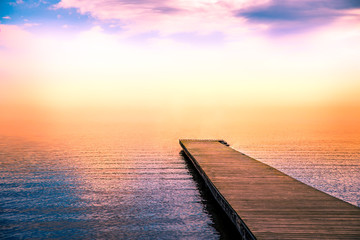 Fototapeta na wymiar tranquil scene of a pier in the sea with fog
