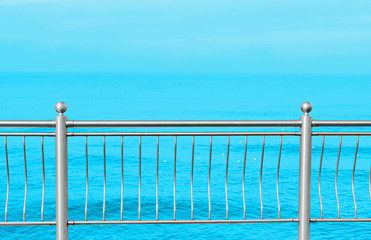 Fototapeta na wymiar sea promenade metallic fence abstract background summer holiday