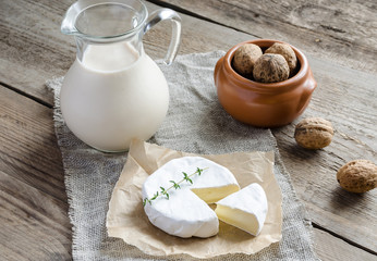 Camembert with pitcher of milk and whole nuts