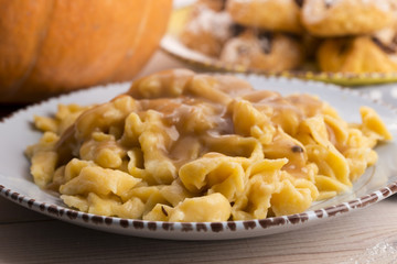 homemade pumpkin tagliatelle with mushrooms