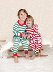 Winter Holidays: Laughing Happy Kids in Christmas Pajamas Sled i