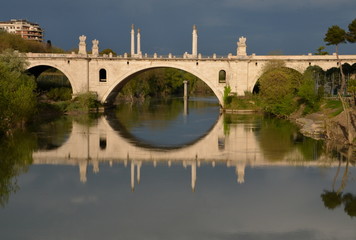 Fototapeta na wymiar Reflections on the Tiber river, Rome, Italy. Flaminio bridge