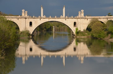 Fototapeta na wymiar Reflections on the Tiber river, Rome, Italy. Flaminio bridge