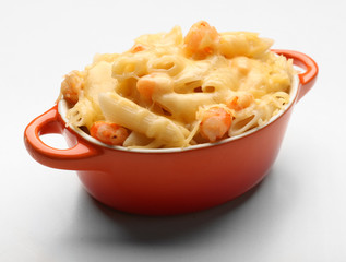 Pasta baked with shrimps and cheese in ceramic pot, isolated