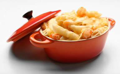 Pasta baked with shrimps and cheese in ceramic pot, isolated