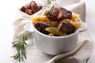 Tasty pasta with meat in ceramic pot