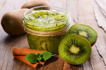 Delicious kiwi jam on table close-up