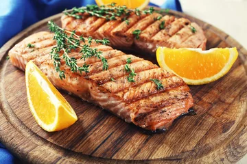 Fototapeten Grilled salmon  and orange slices © Africa Studio