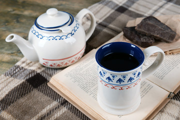 Cup of tea with book on table close-up