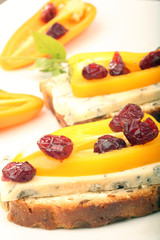 Sandwich with mold cheese, sweet peppers and cranberries on whit