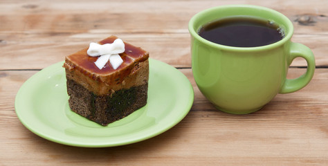 tea cup with colorful cookies, and  brown muffin on table