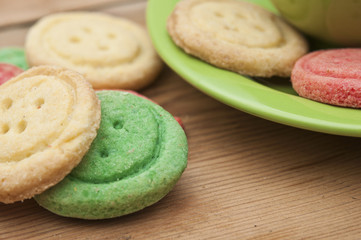 Multicolored sugar cookies on wooden background