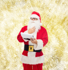man in costume of santa claus with notepad