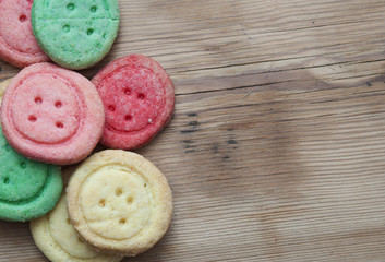 Multicolored sugar cookies on wooden background