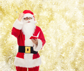 man in costume of santa claus with notepad