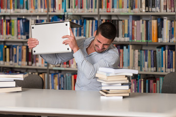 Frustrated Student Throwing His Laptop