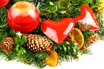 Christmas decoration with candle, cone and fruit