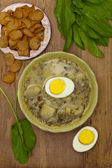 Sorrel soup with egg and greens. Selective focus.