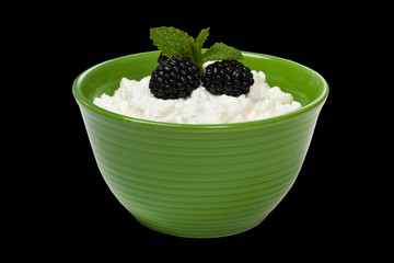 Cottage cheese with fresh blackberries. Selective focus.