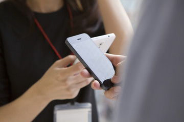 Men and women who have a cell phone and face to face