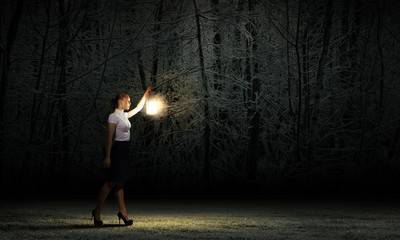 Businesswoman with lantern