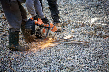 Close up of rebar being cut at a construction site. 